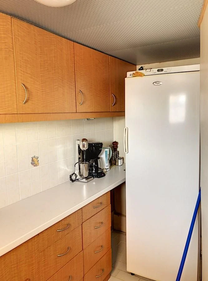 a kitchen with a refrigerator and a coffee maker aboard ELIKI Yacht for Sale