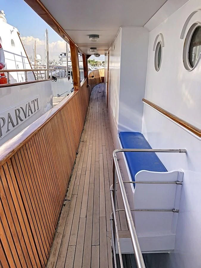 a wooden walkway with a railing aboard ELIKI Yacht for Sale