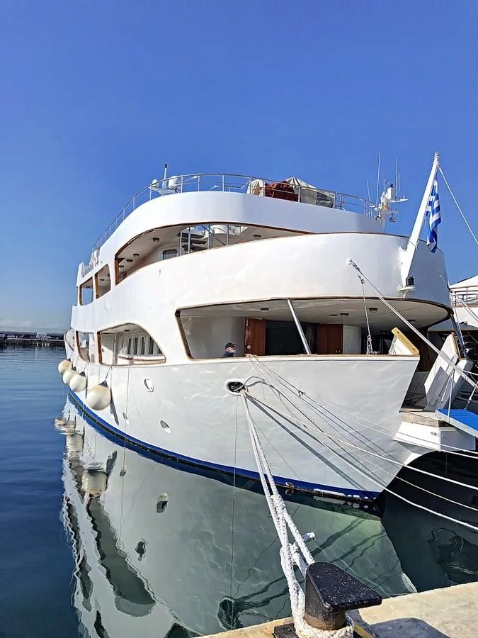 a boat docked at a pier aboard ELIKI Yacht for Sale