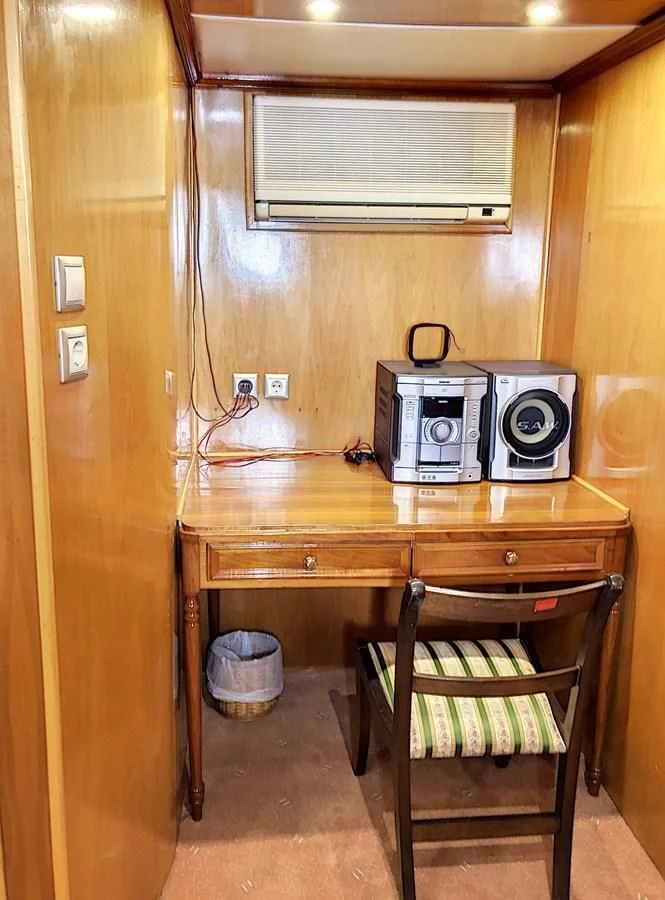 a kitchen with a microwave oven and a wood table aboard ELIKI Yacht for Sale