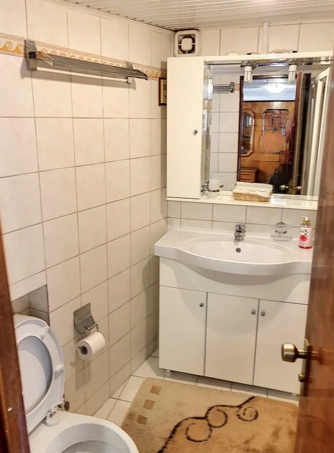 a bathroom with a sink and toilet aboard ELIKI Yacht for Sale