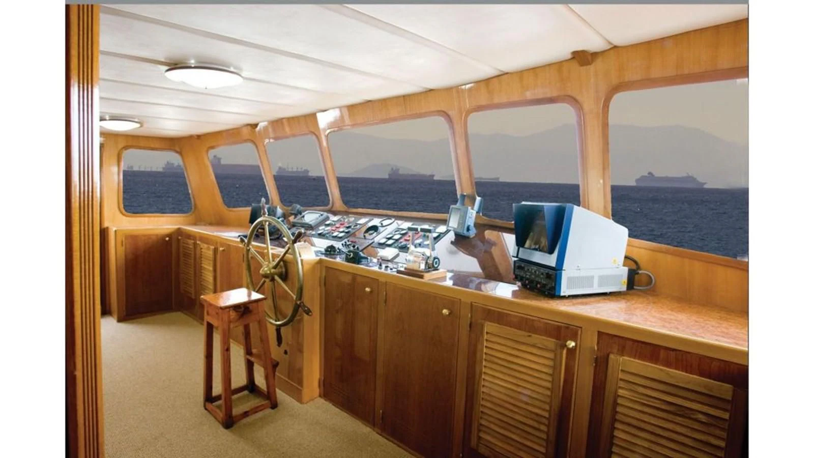 a room with a table and a computer on a counter aboard ELIKI Yacht for Sale