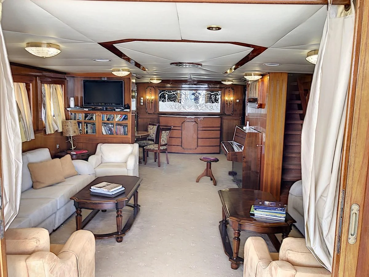 a living room with a couch and a television aboard ELIKI Yacht for Sale