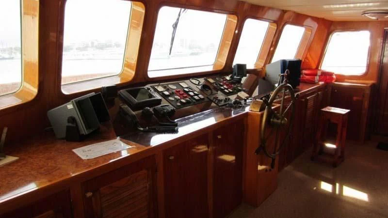 a room with a desk and a window aboard ELIKI Yacht for Sale