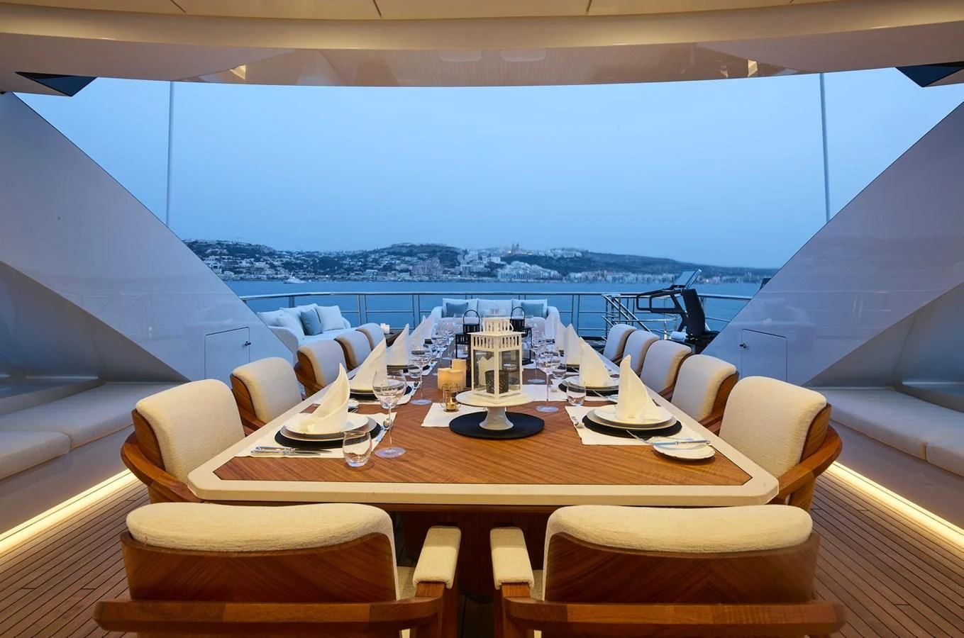 a table with chairs and a view of the ocean aboard COME TOGETHER Yacht for Charter
