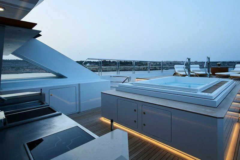 a large white boat on a deck aboard COME TOGETHER Yacht for Charter
