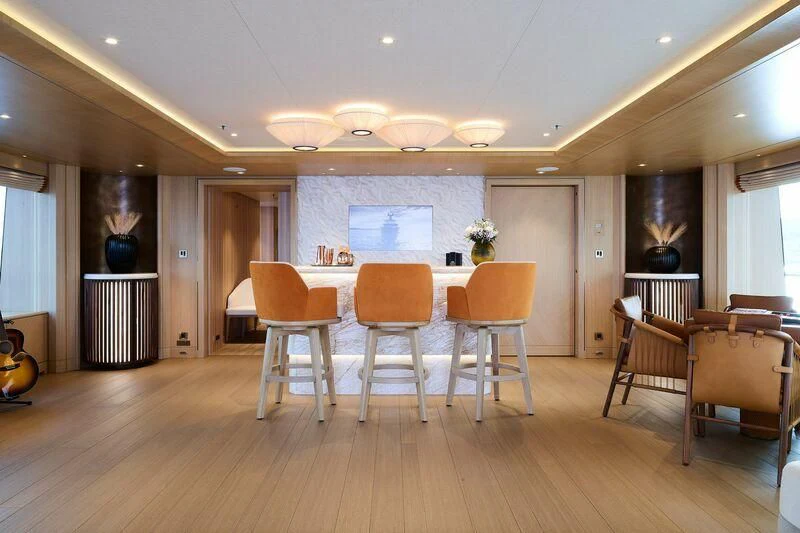 a large empty room with chairs and a table aboard COME TOGETHER Yacht for Charter