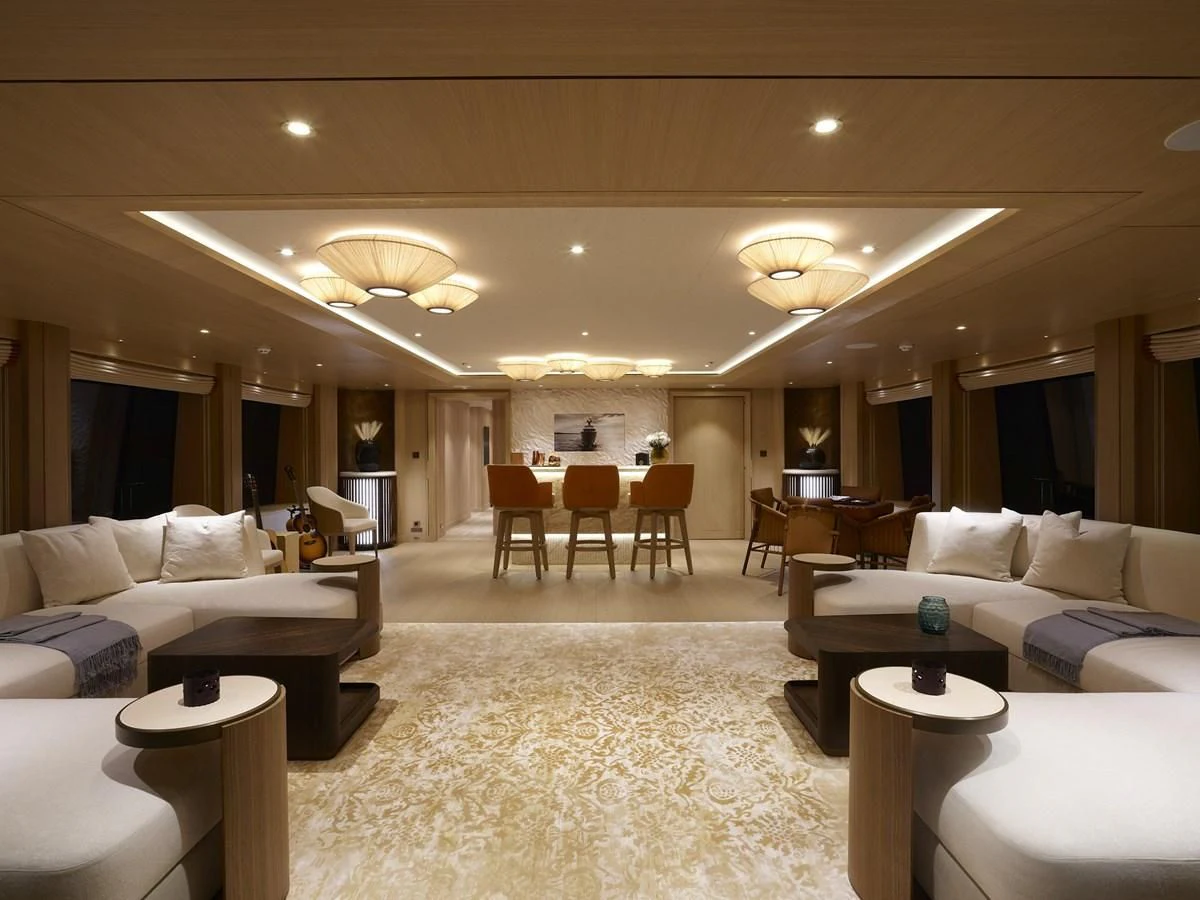 a large living room with white furniture aboard COME TOGETHER Yacht for Charter