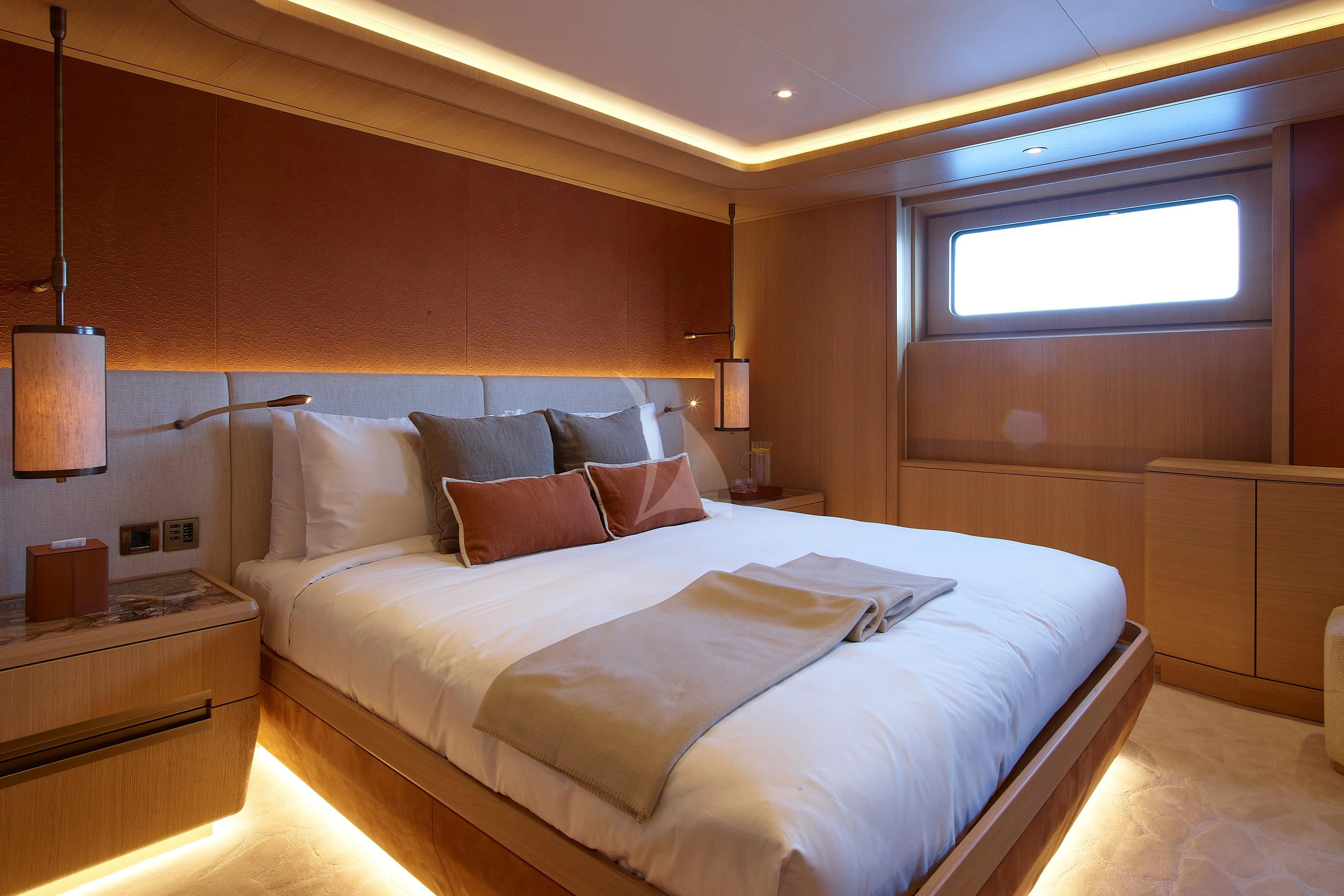 a bed with a white comforter aboard COME TOGETHER Yacht for Charter