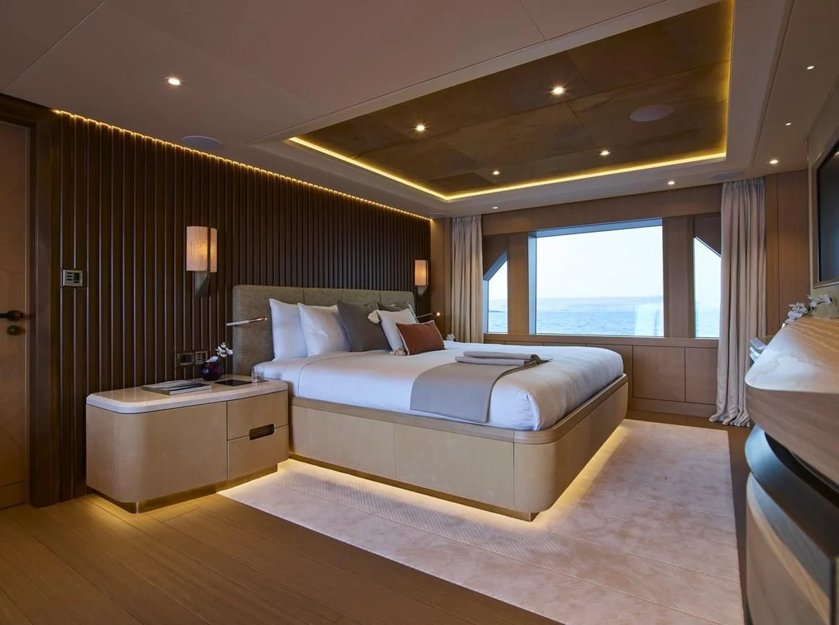 a hotel room with a bed and a window aboard COME TOGETHER Yacht for Charter