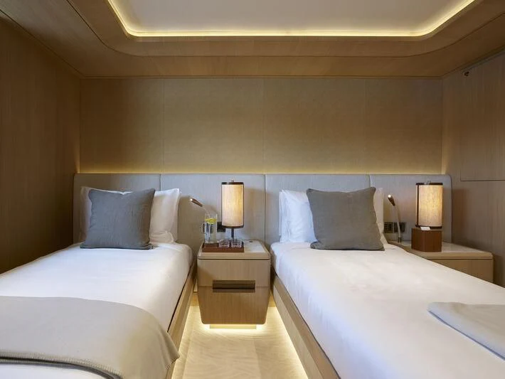 a hotel room with two beds aboard COME TOGETHER Yacht for Charter