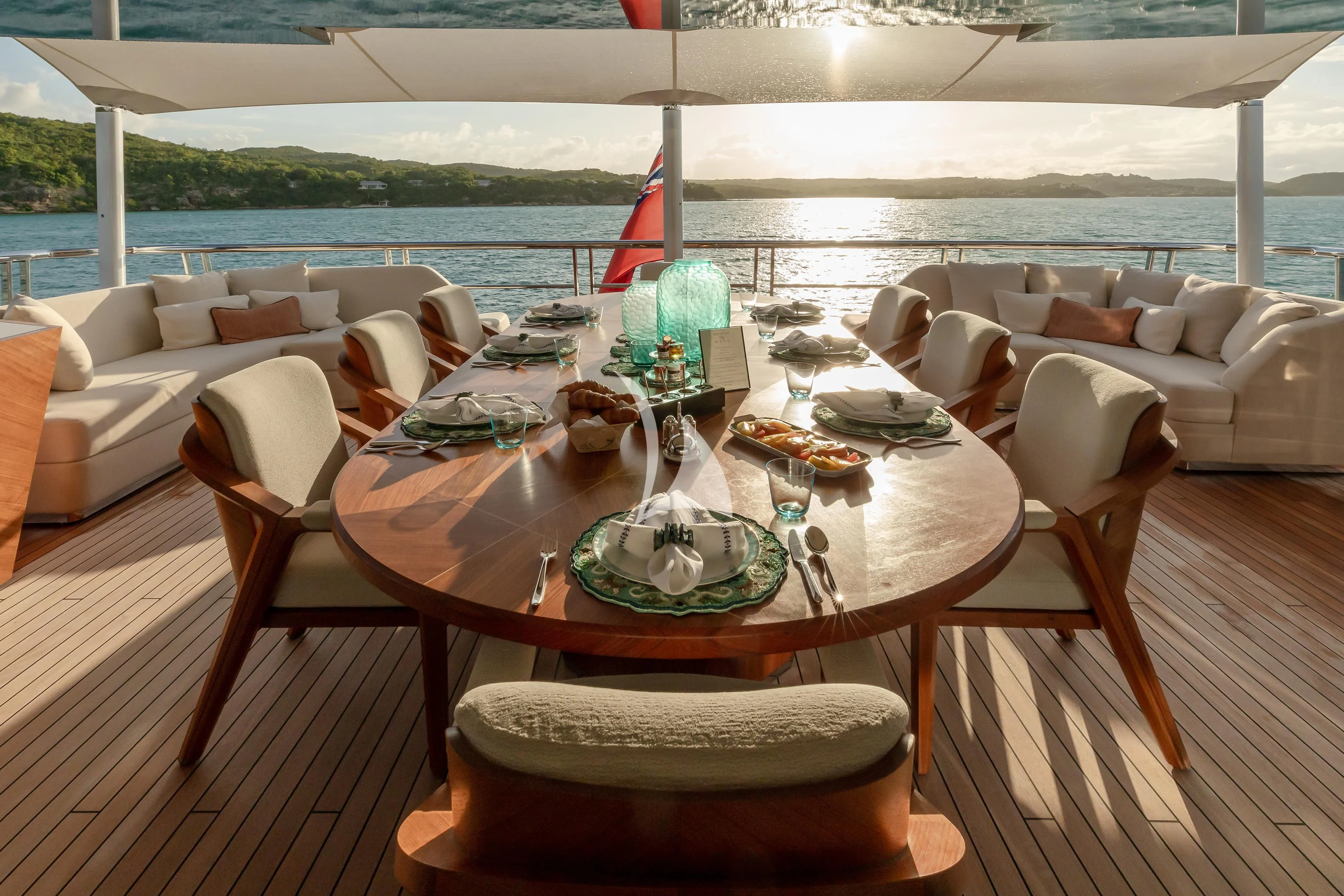 a table with plates and chairs on it aboard COME TOGETHER Yacht for Charter