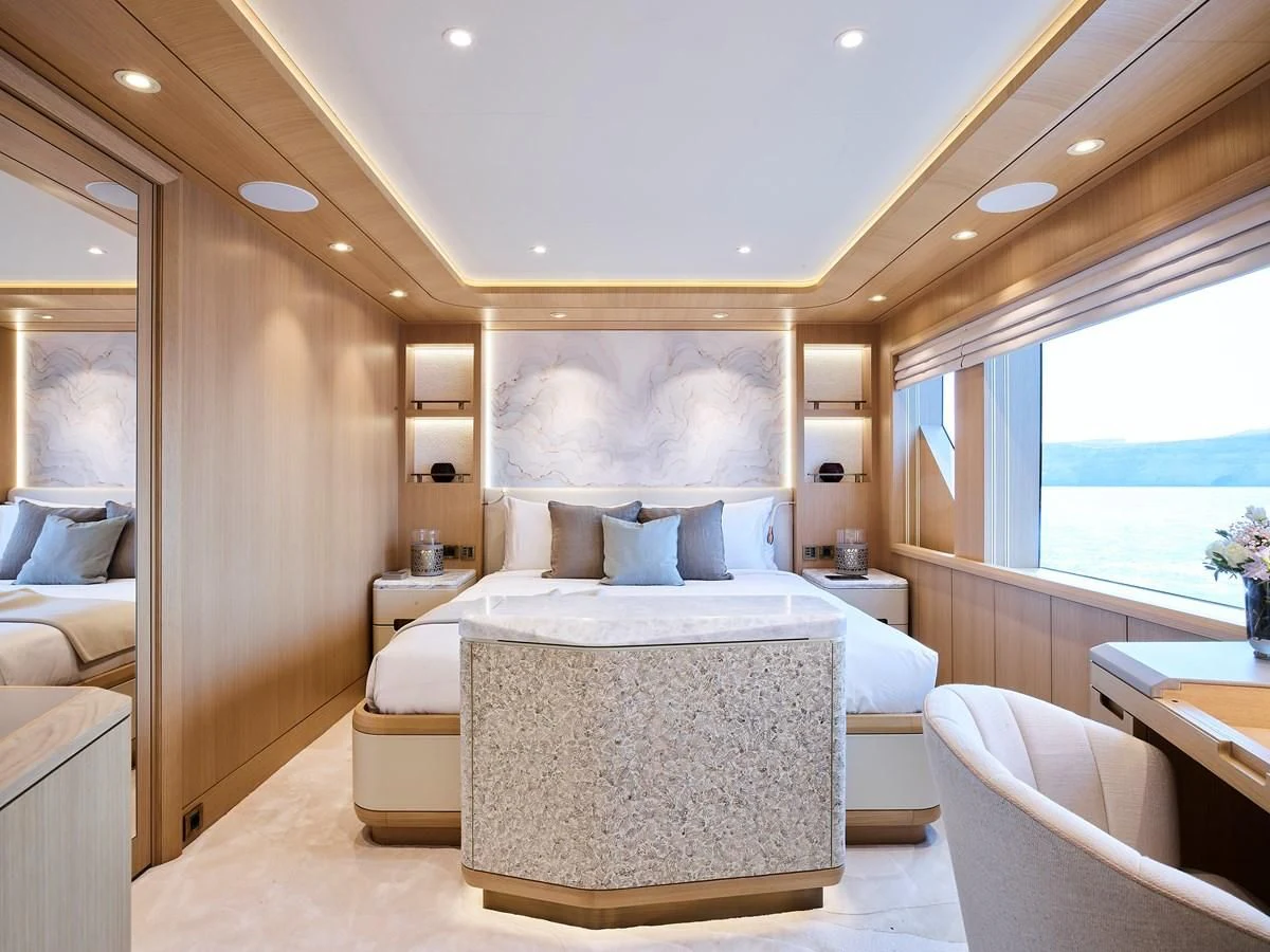 a room with a bed and a window aboard COME TOGETHER Yacht for Charter
