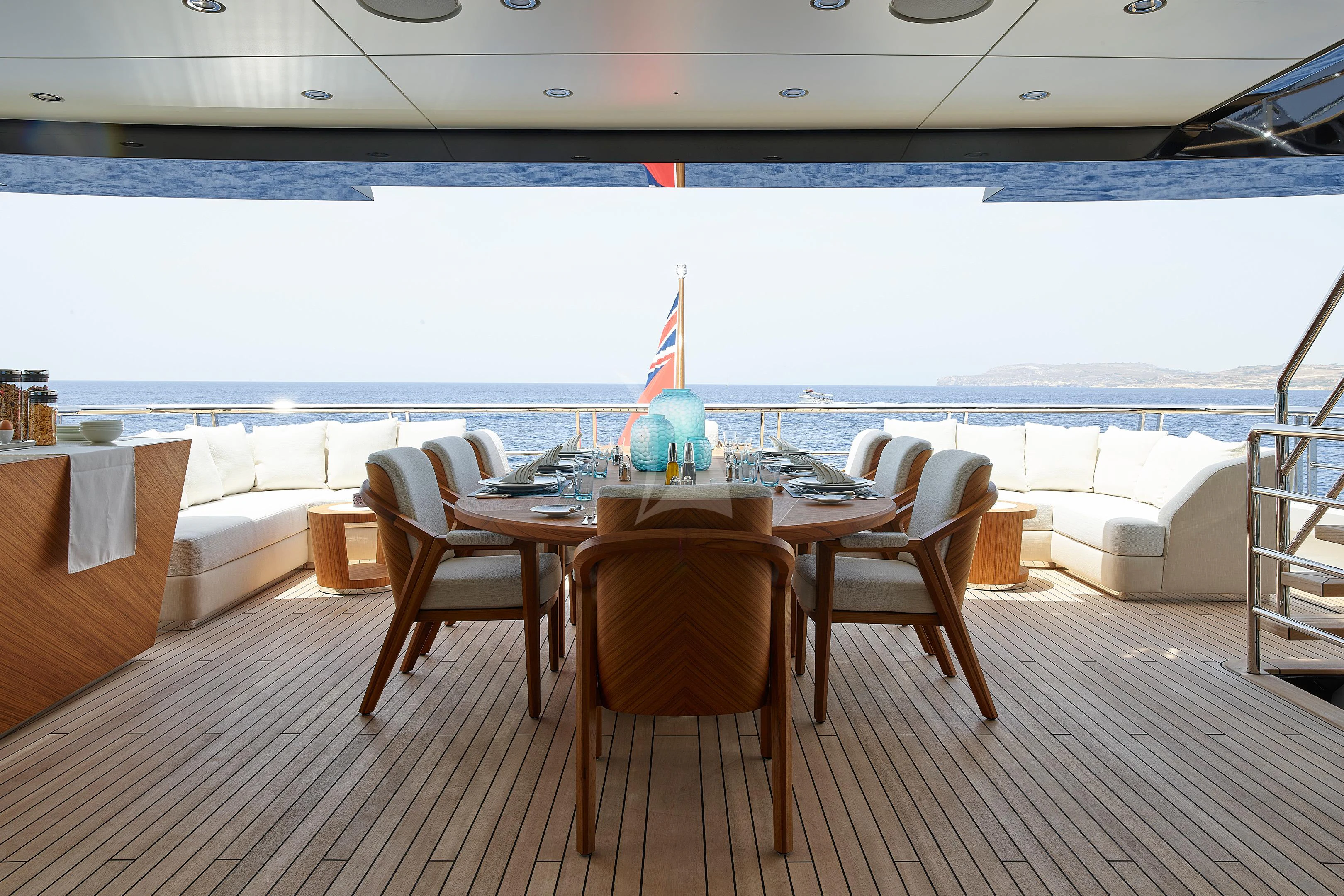 a table and chairs on a deck aboard COME TOGETHER Yacht for Charter