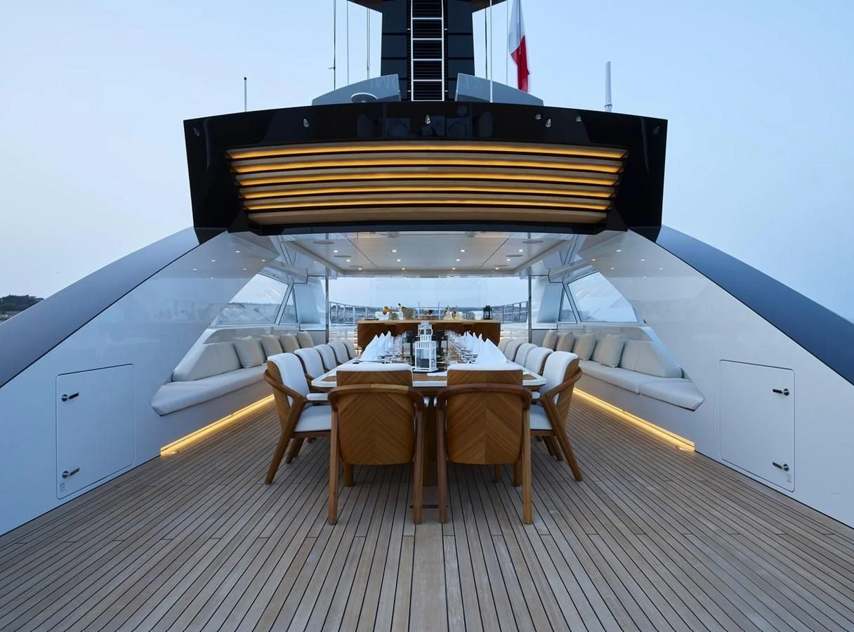 a large white and blue room with a table and chairs aboard COME TOGETHER Yacht for Charter