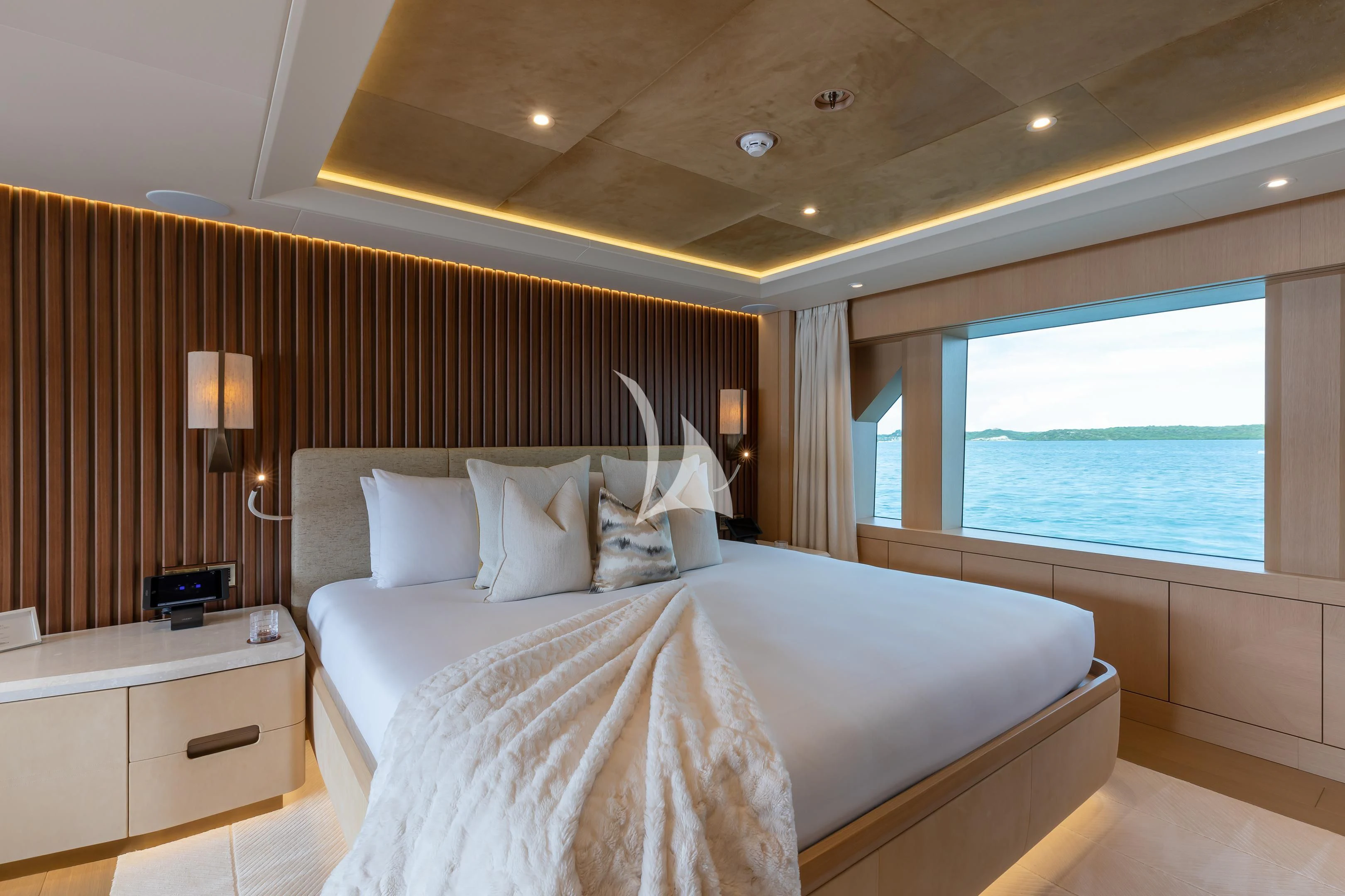 a hotel room with a large bed aboard COME TOGETHER Yacht for Charter