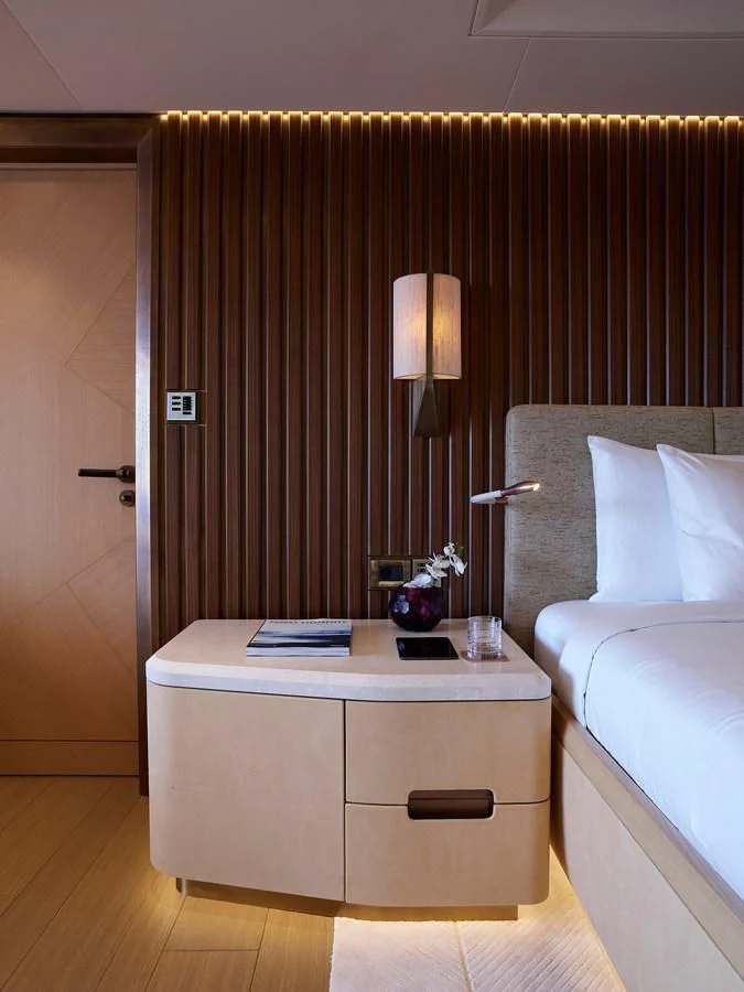 a room with a bed and a desk aboard COME TOGETHER Yacht for Charter