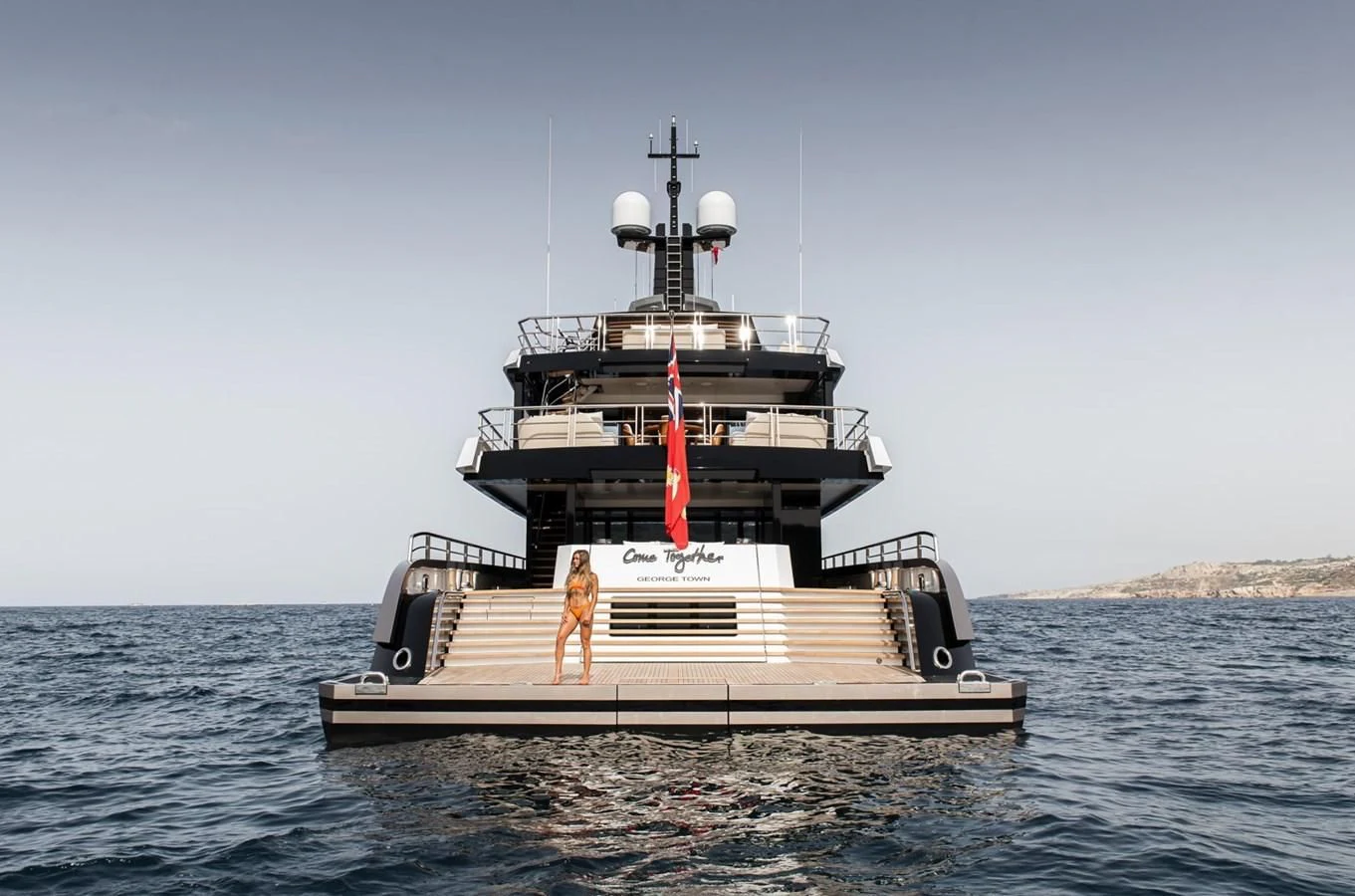 a boat in the water with Thomas Point Shoal Light in the background aboard COME TOGETHER Yacht for Charter