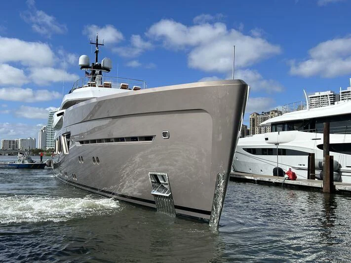 a large white boat is parked next to a smaller boat aboard COME TOGETHER Yacht for Charter