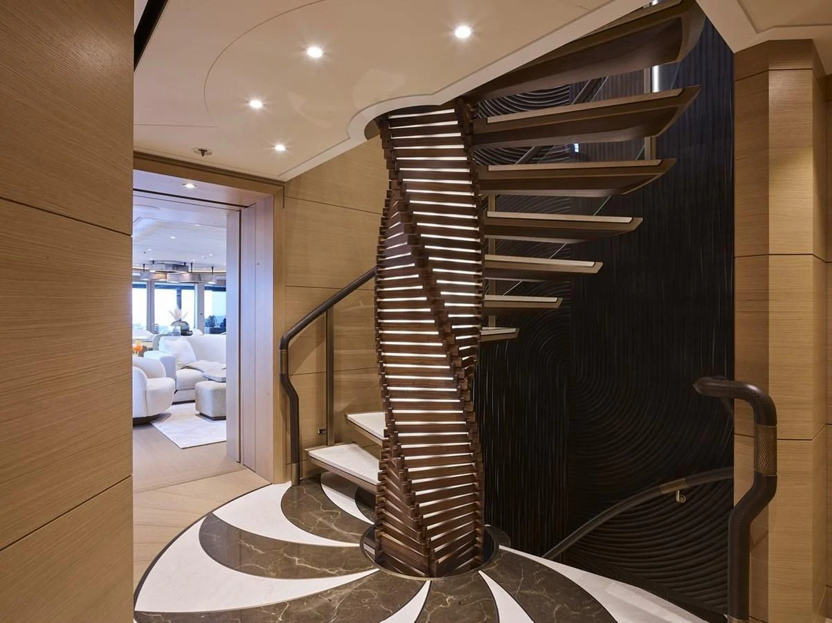 a black spiral staircase in a room aboard COME TOGETHER Yacht for Charter