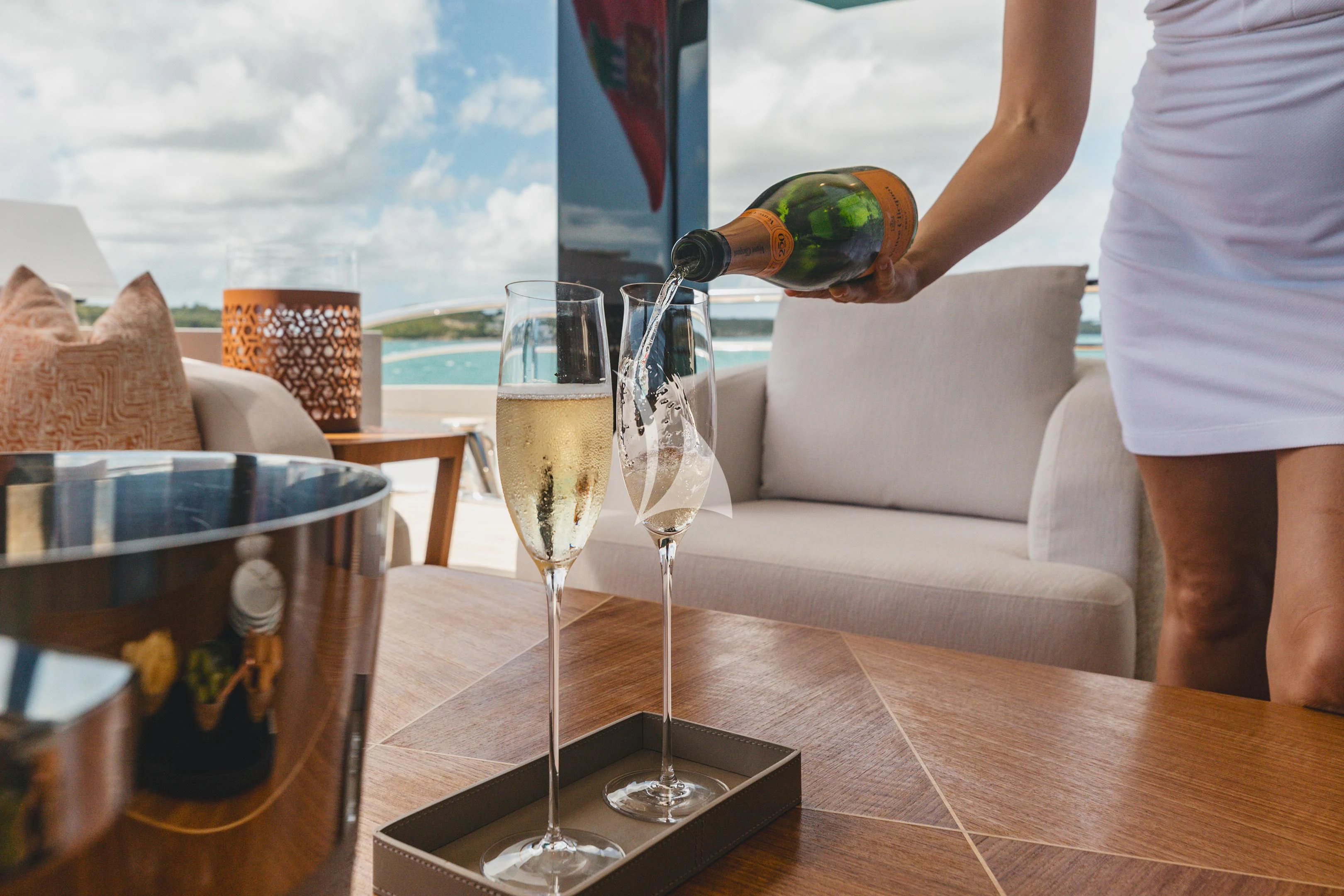 a person pouring a glass of wine aboard COME TOGETHER Yacht for Charter