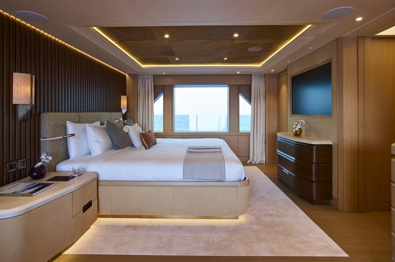 a hotel room with a bed and a tv aboard COME TOGETHER Yacht for Charter