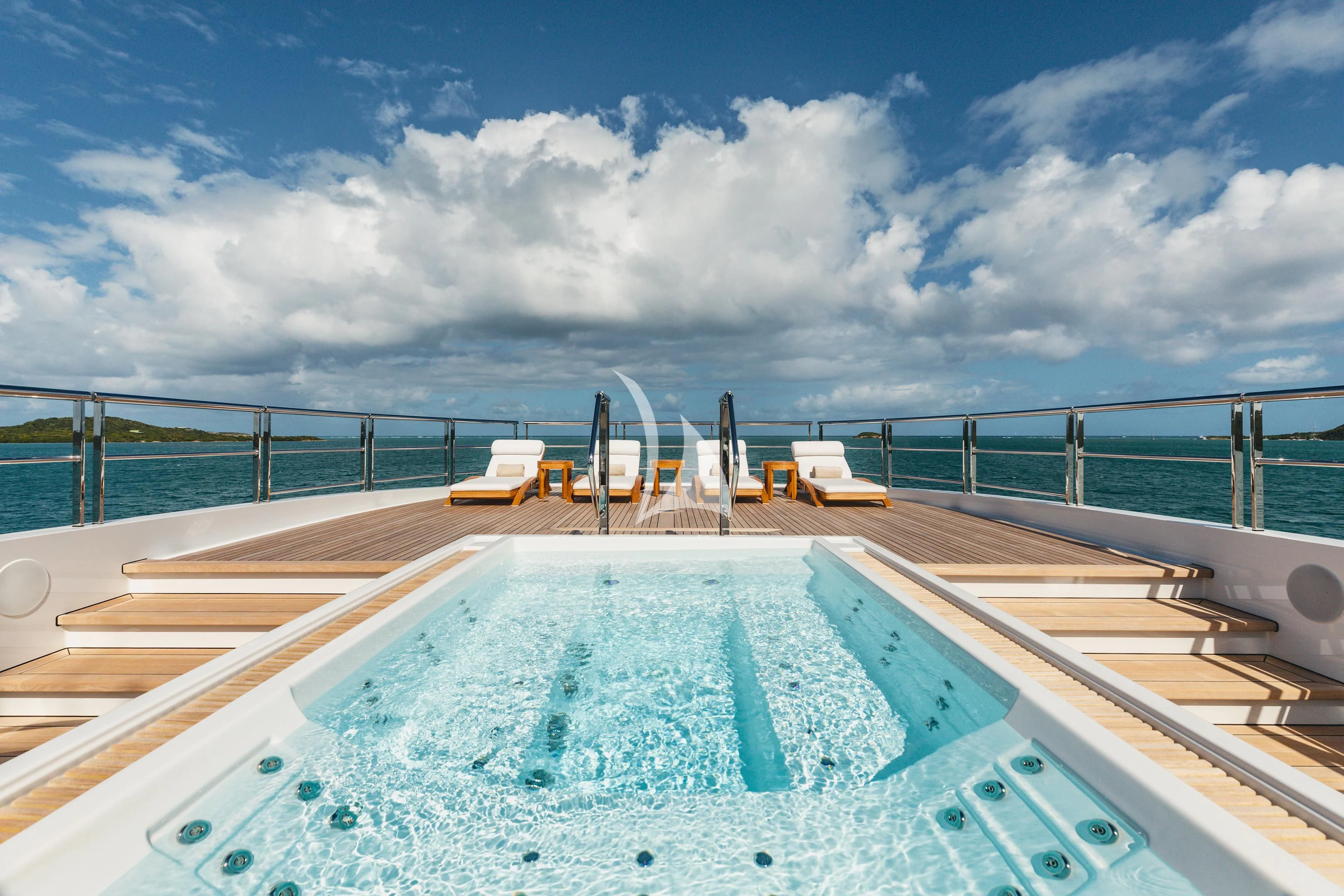 a swimming pool with chairs and a deck and a cloudy sky aboard COME TOGETHER Yacht for Charter