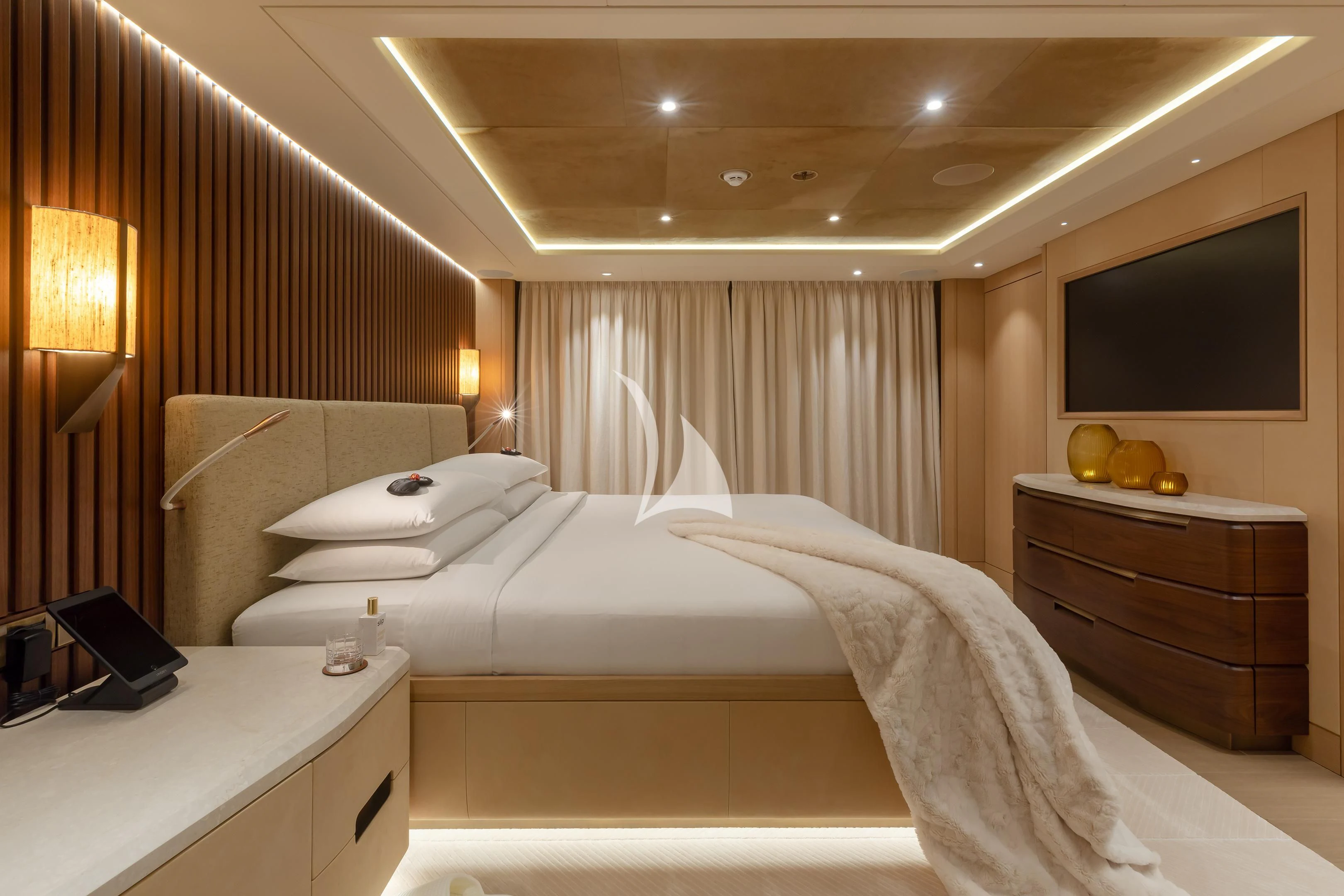 a room with a bed and a television aboard COME TOGETHER Yacht for Charter