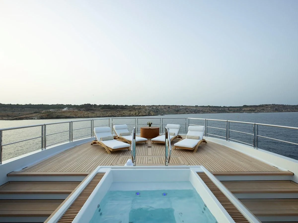 a deck with chairs and tables on it aboard COME TOGETHER Yacht for Charter