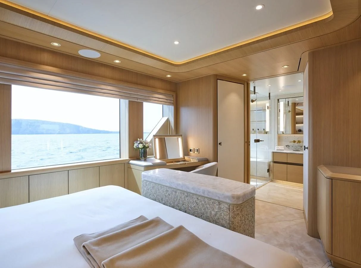 a bedroom with a bed and a desk aboard COME TOGETHER Yacht for Charter