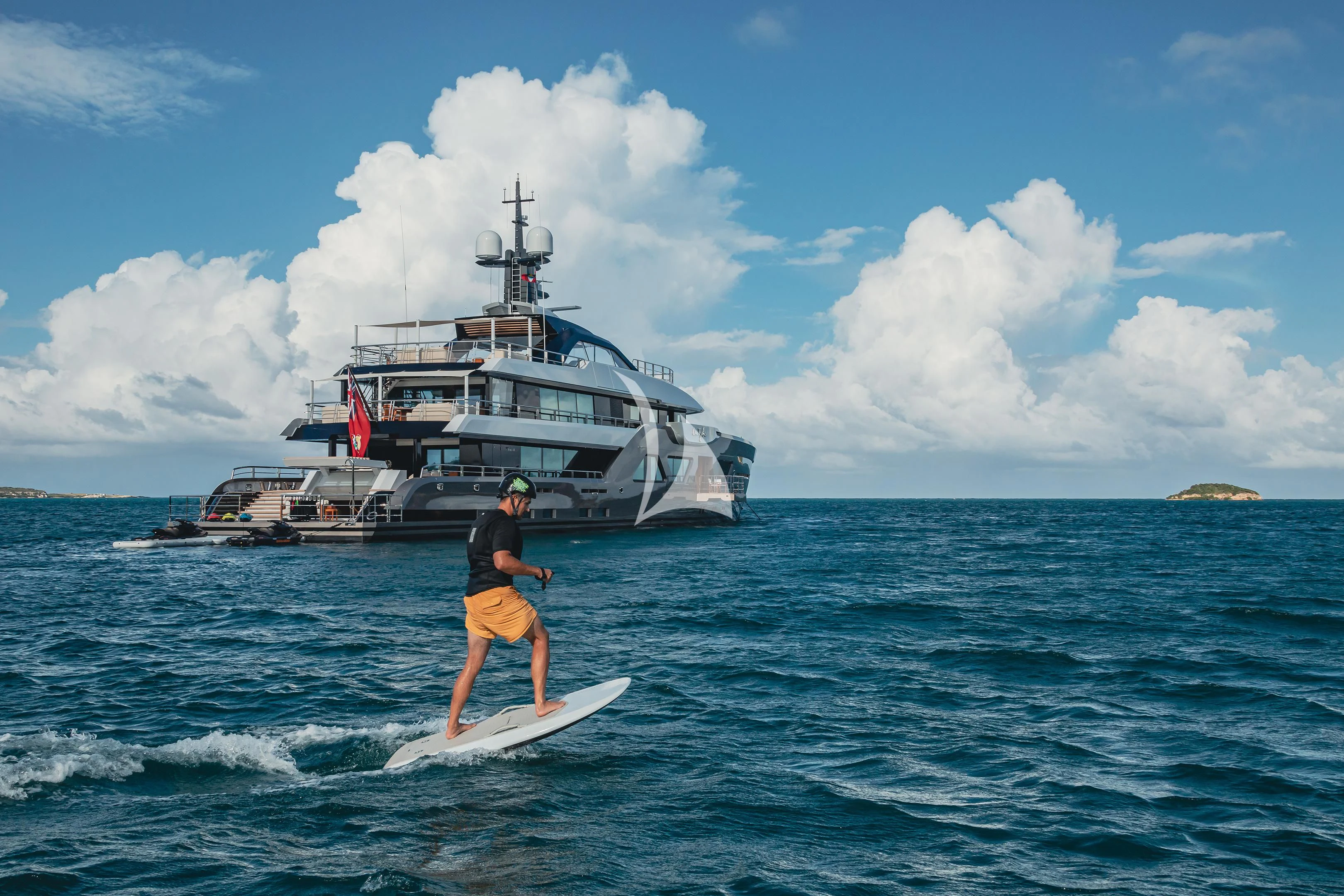 a man surfing in the sea aboard COME TOGETHER Yacht for Charter