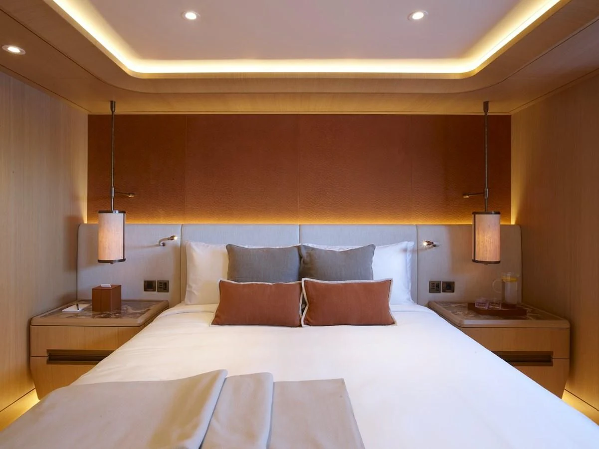 a bed with white sheets aboard COME TOGETHER Yacht for Charter