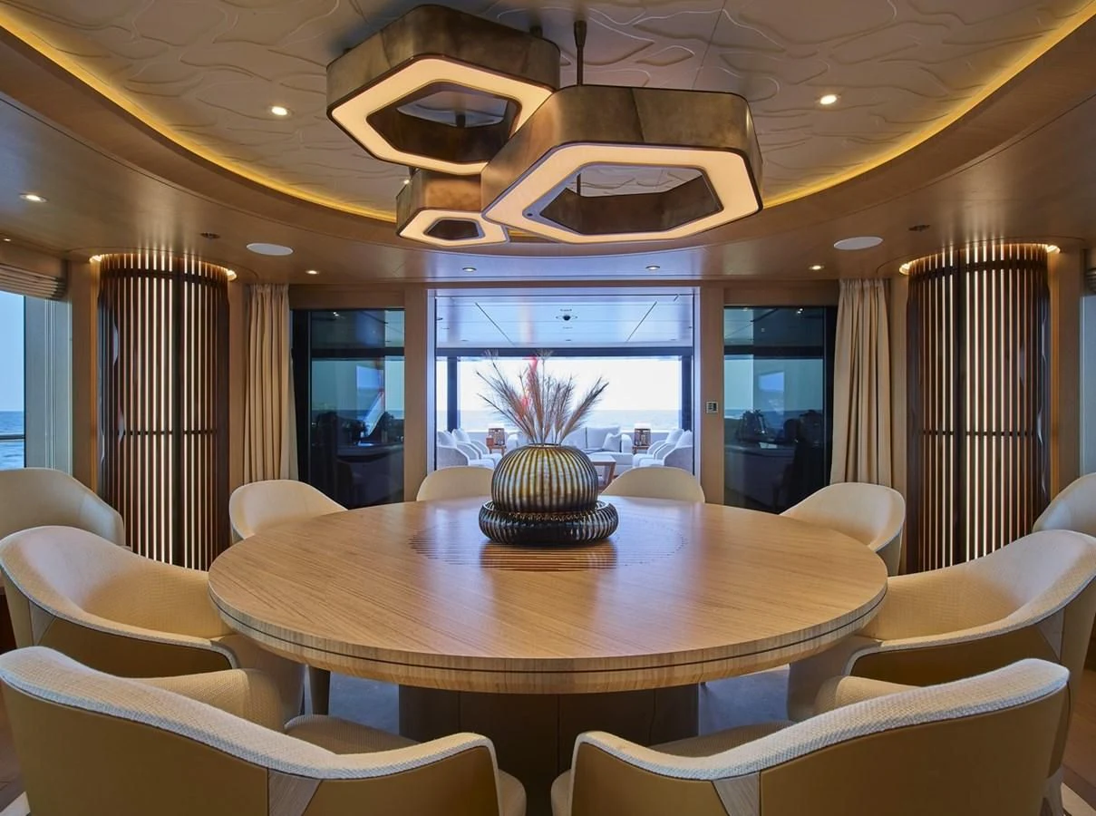 a dining room with a round table aboard COME TOGETHER Yacht for Charter