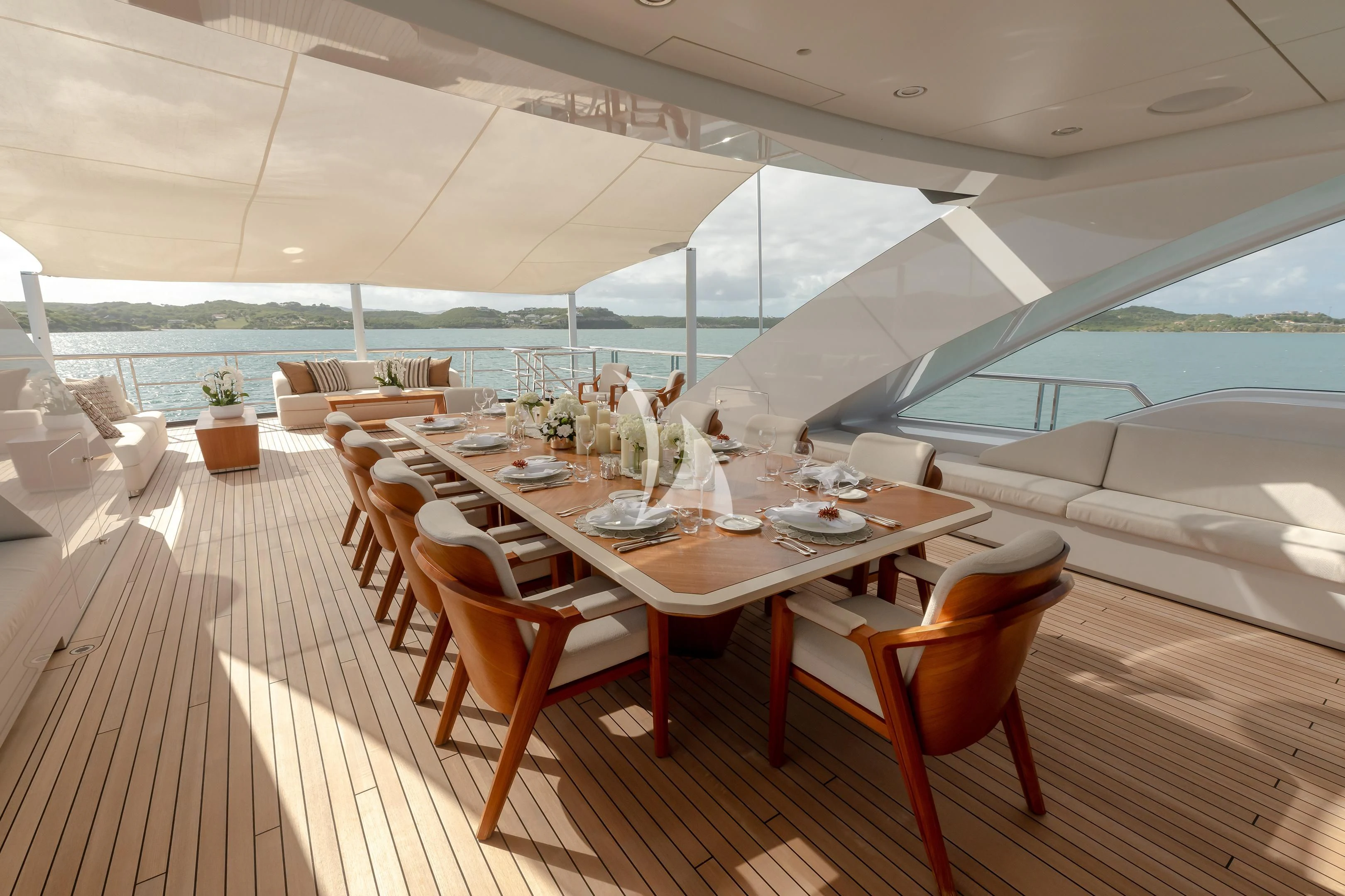 a table set for a meal on a deck aboard COME TOGETHER Yacht for Charter