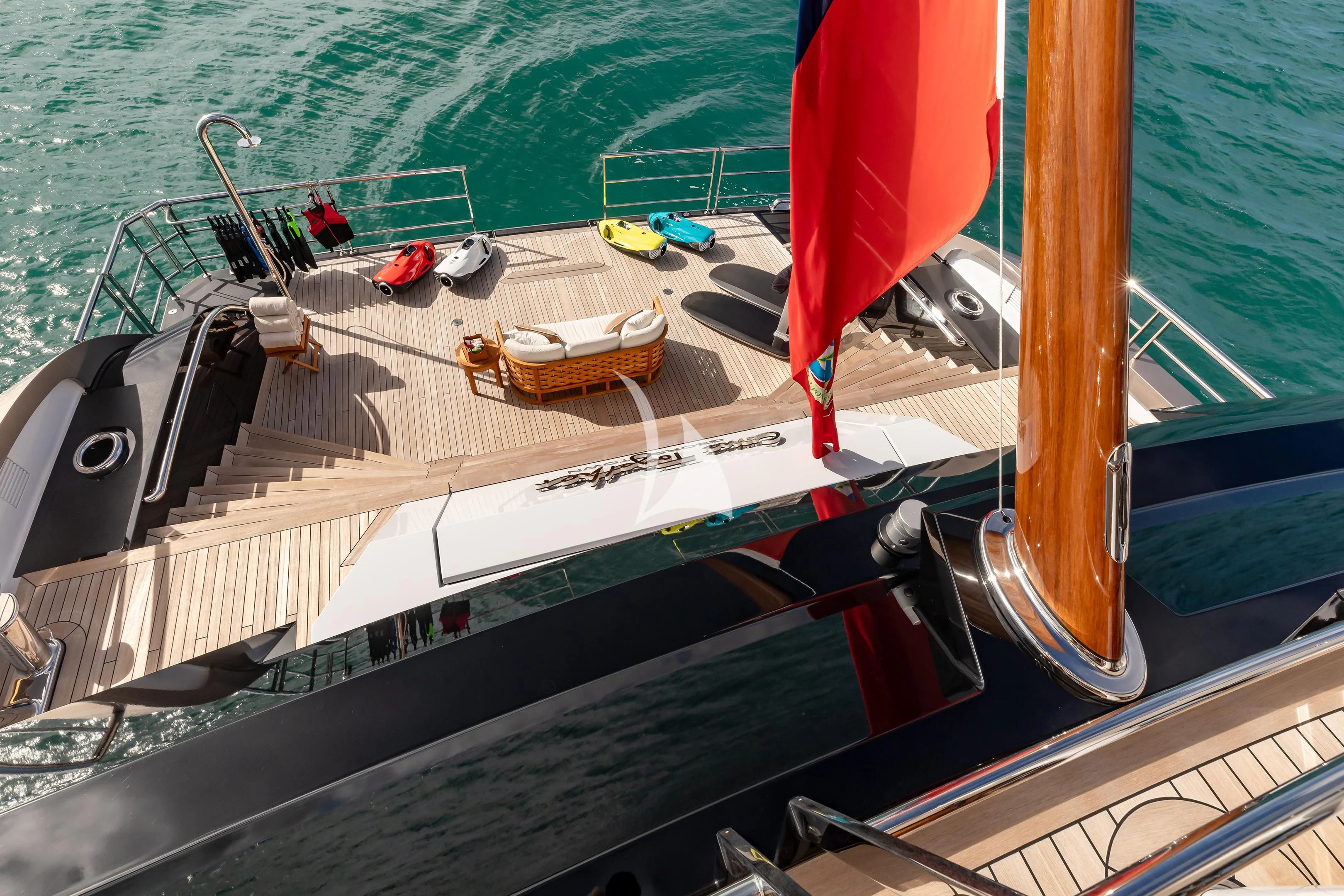 a boat with a red sail aboard COME TOGETHER Yacht for Charter