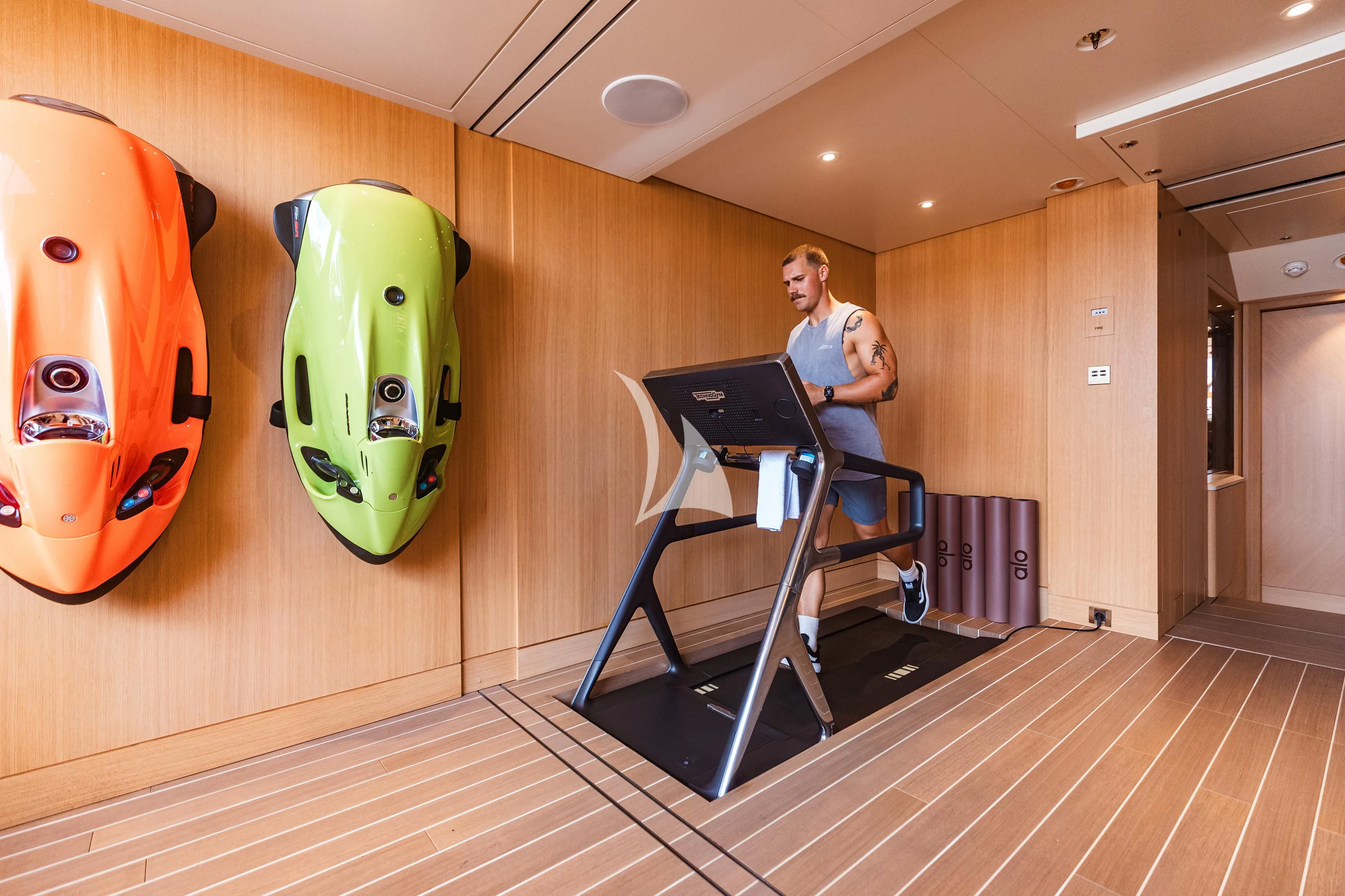 a person sitting on a chair in a room with a laptop and a large balloon aboard COME TOGETHER Yacht for Charter