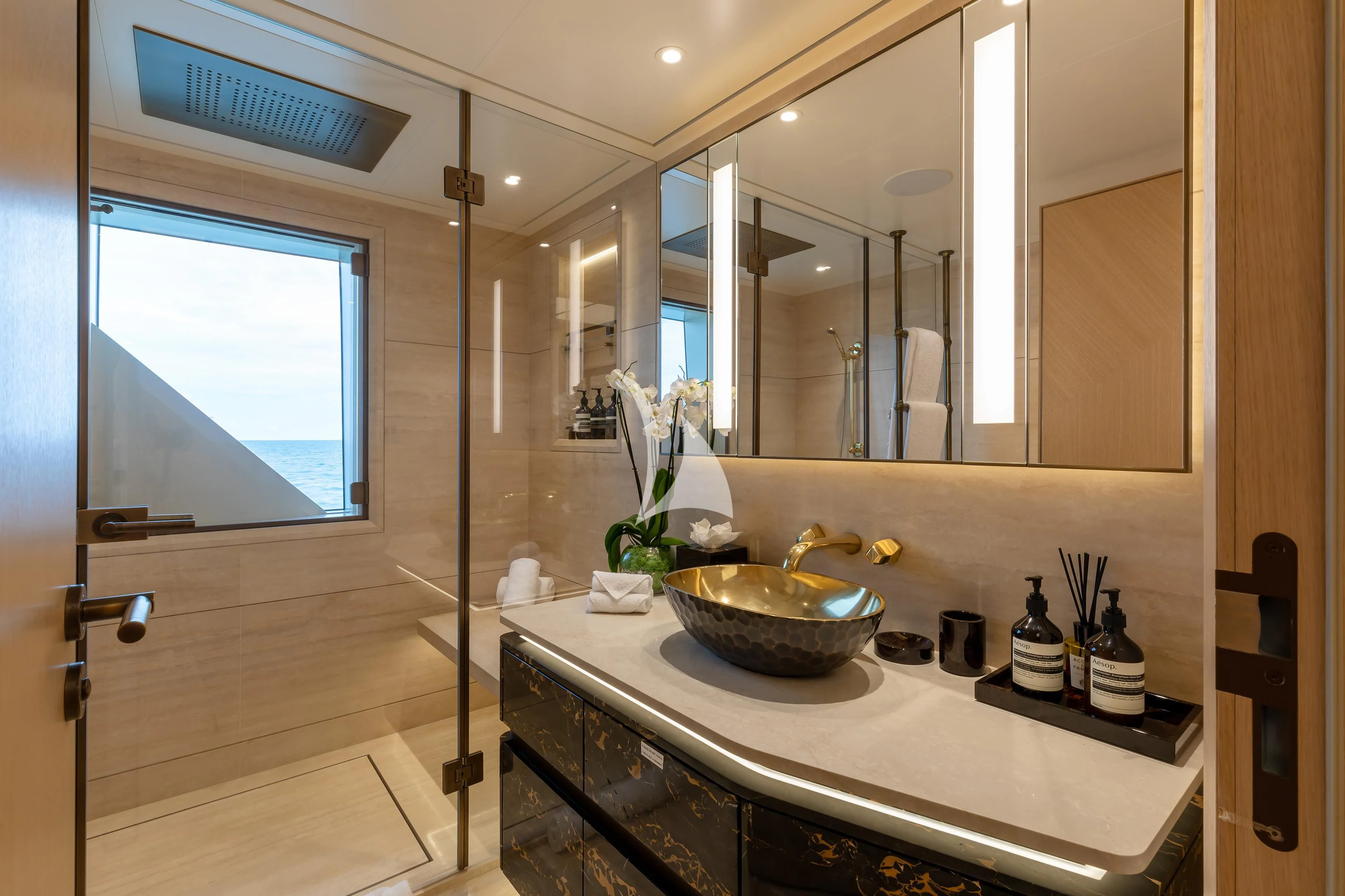 a bathroom with a sink and a large mirror aboard COME TOGETHER Yacht for Charter