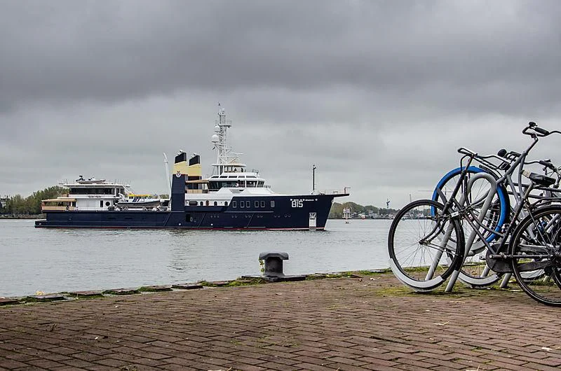a boat is parked next to a large ship aboard SHERPA Yacht for Sale