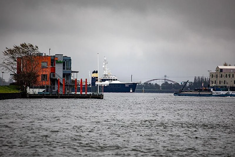 a body of water with boats and buildings in the background aboard SHERPA Yacht for Sale