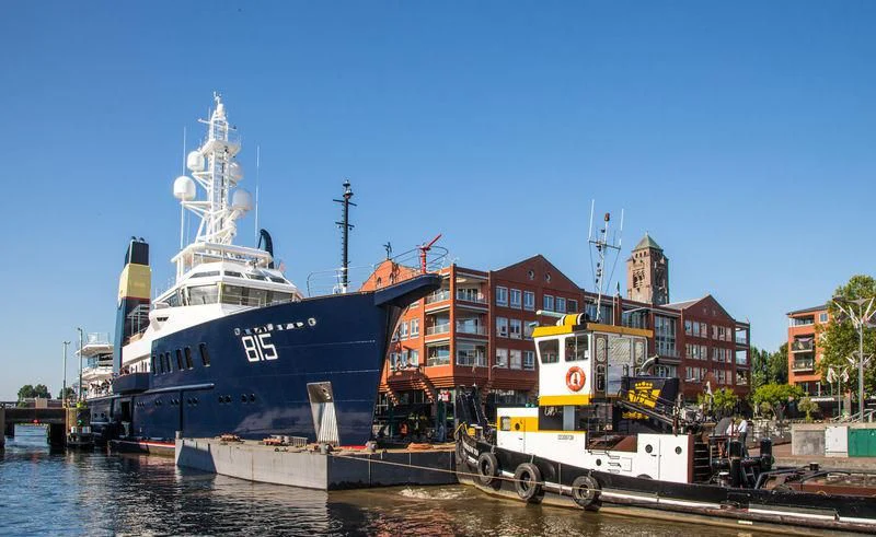 a large ship docked at a dock aboard SHERPA Yacht for Sale