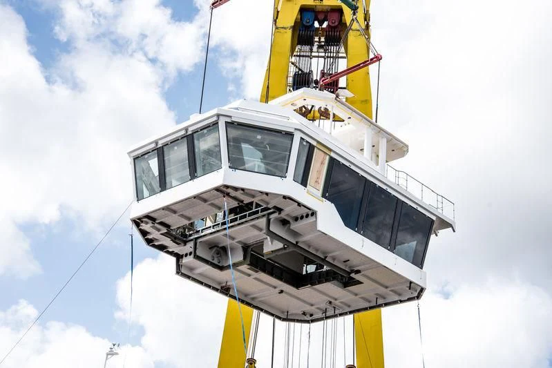 a white boat with a yellow crane aboard SHERPA Yacht for Sale