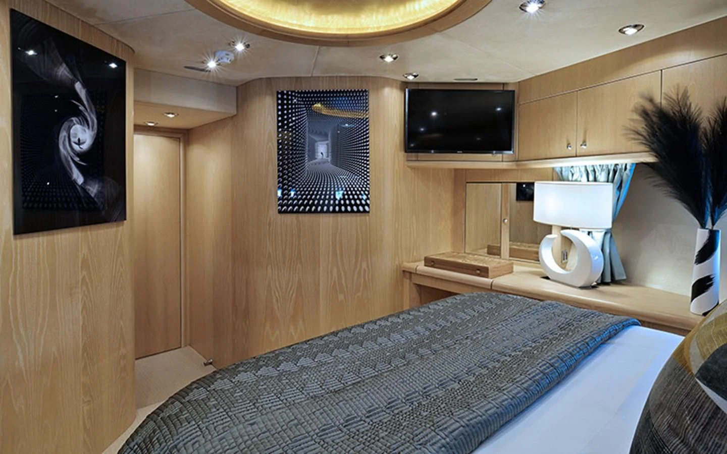 a bed with a television on the wall aboard EXCELERATE Z Yacht for Sale
