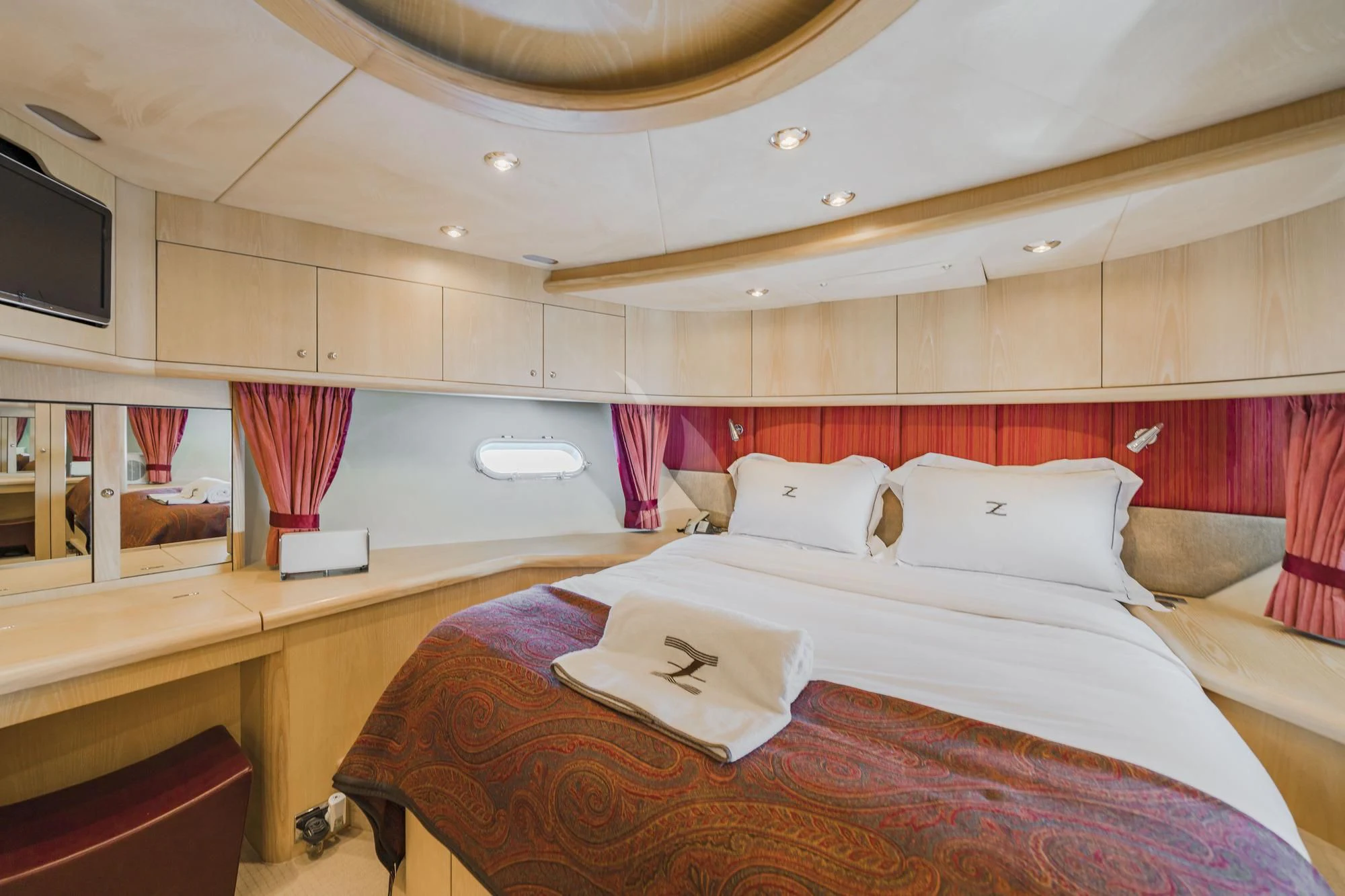 a room with a bed and a desk aboard EXCELERATE Z Yacht for Sale
