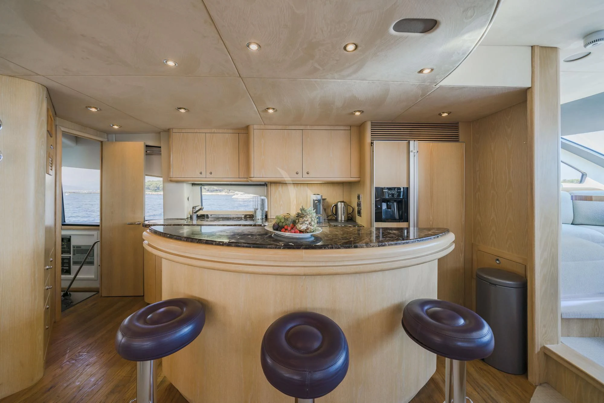 a kitchen with a stool and a bar stool aboard EXCELERATE Z Yacht for Sale