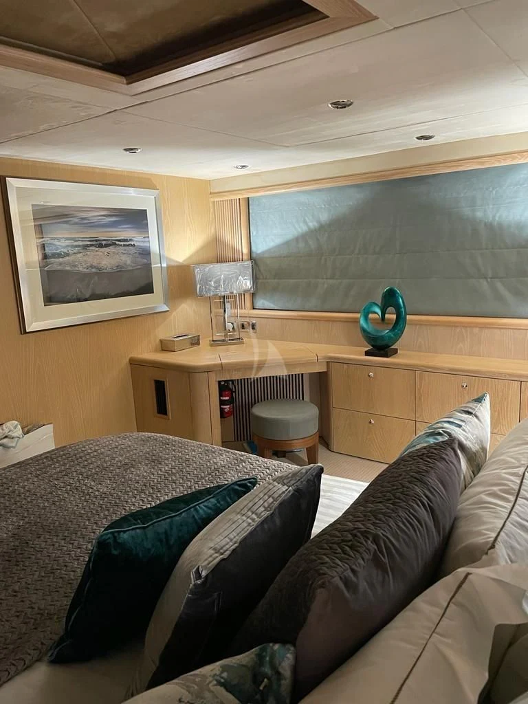 a bedroom with a desk and a bed aboard EXCELERATE Z Yacht for Sale