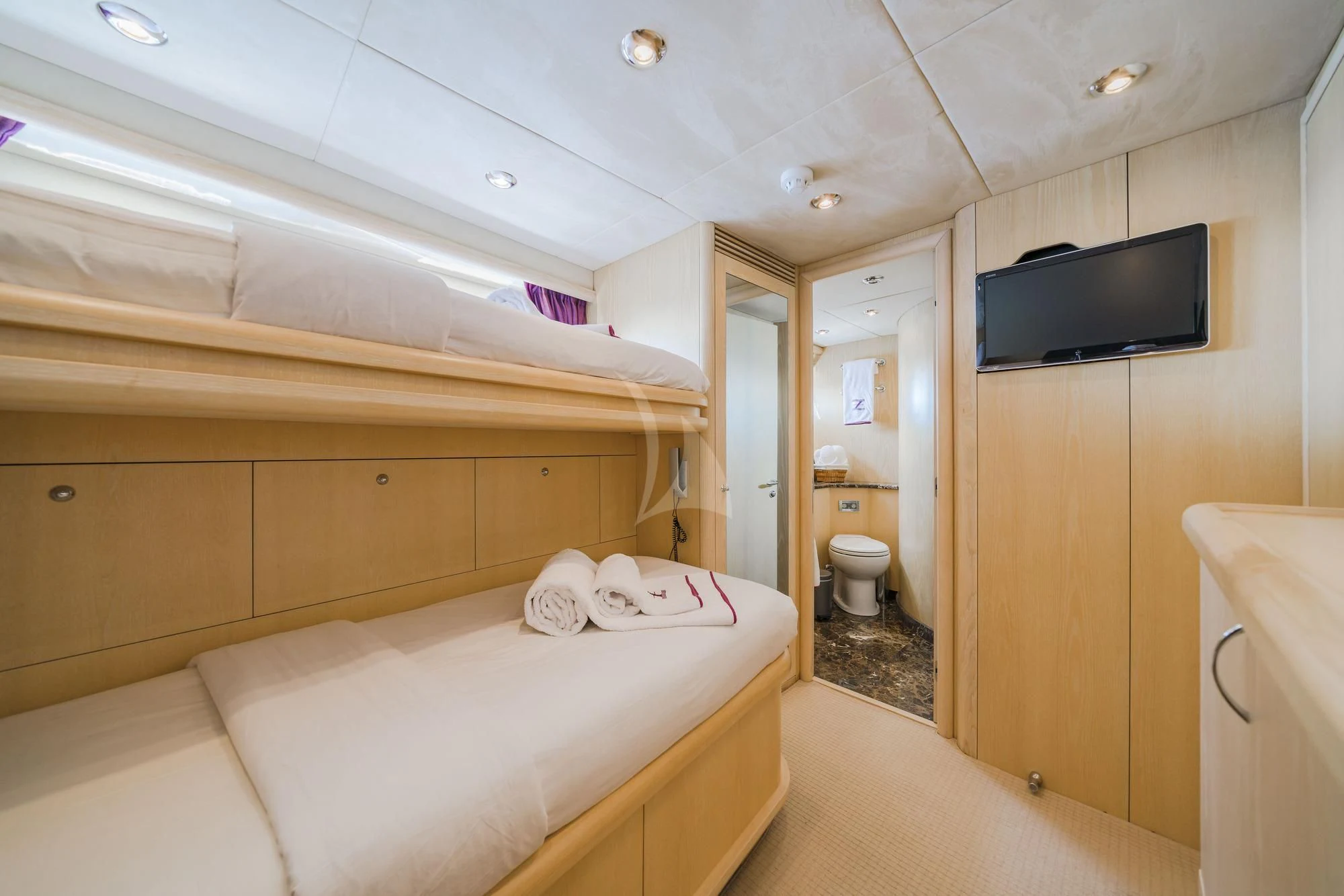 a room with a bed and a television aboard EXCELERATE Z Yacht for Sale