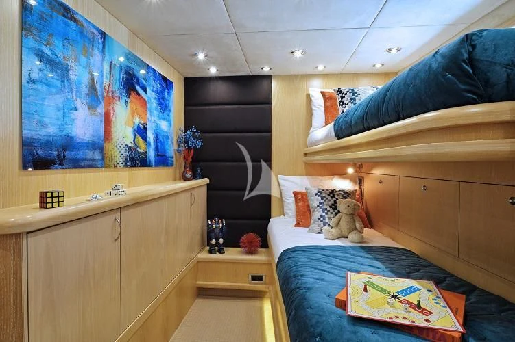 a bedroom with a blue bed and a blue bed spread aboard EXCELERATE Z Yacht for Sale