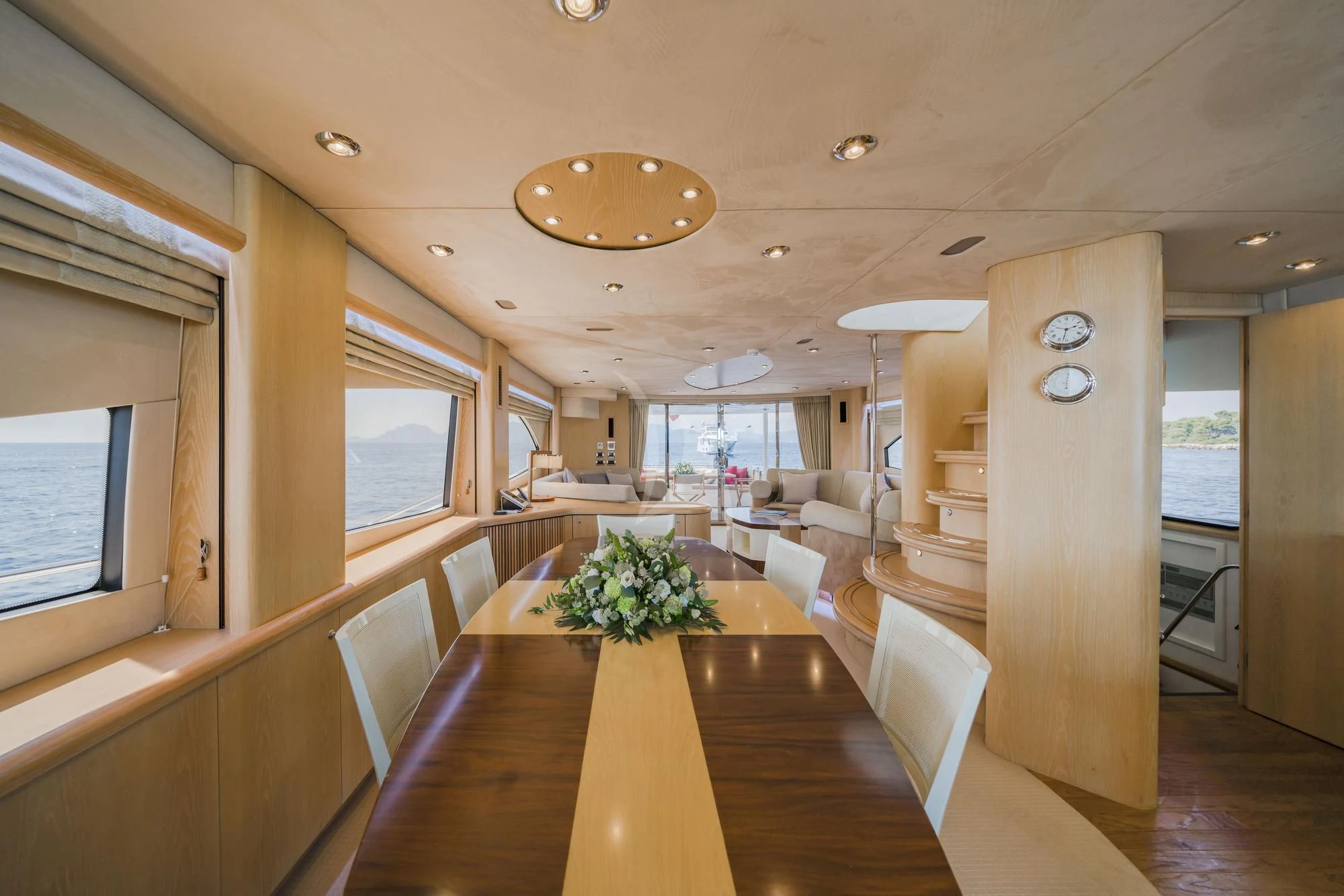 a large room with a table and chairs aboard EXCELERATE Z Yacht for Sale