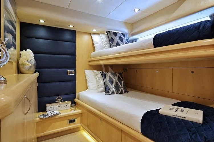 a room with a bed and a dresser aboard EXCELERATE Z Yacht for Sale