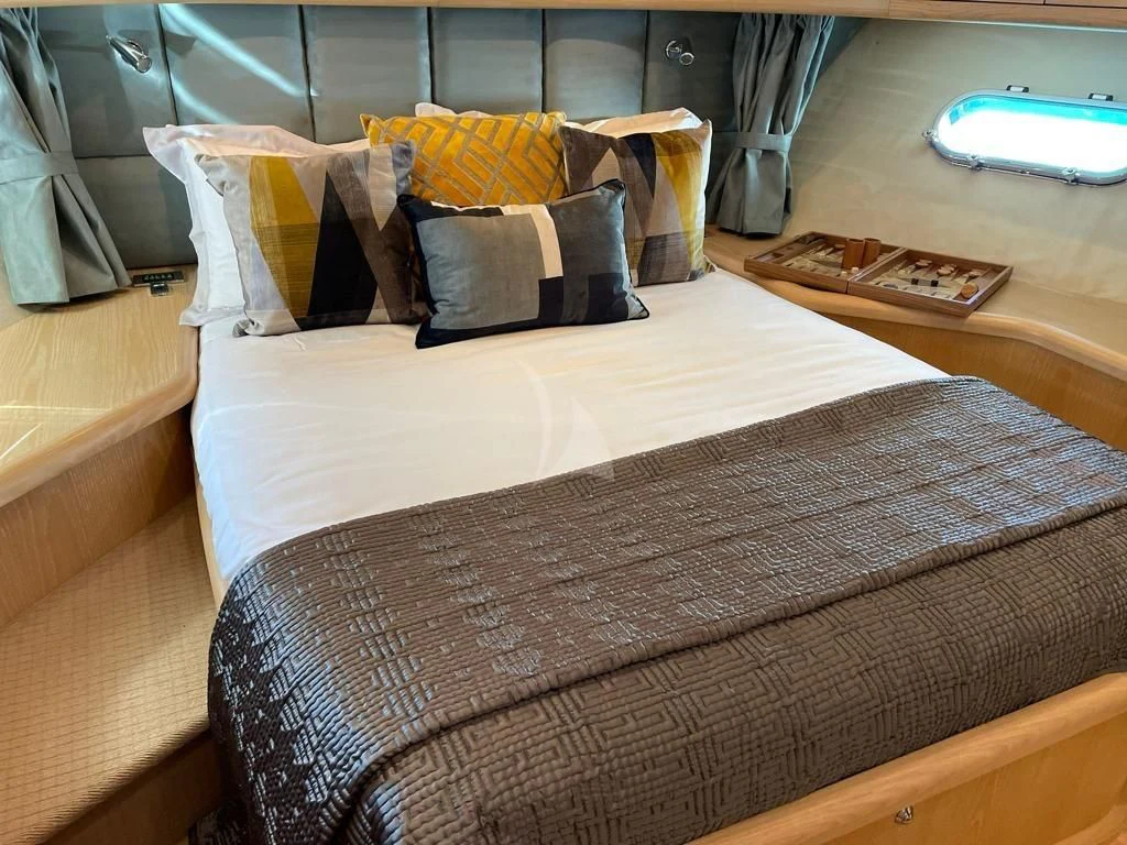 a bed with pillows aboard EXCELERATE Z Yacht for Sale